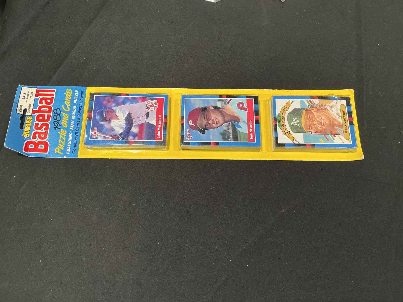 1988 Donruss Baseball Puzzle & Cards 75-Card Pack: Making another appearance, this vintage 1988 Donruss Baseball Puzzle & Cards package contains 75 cards plus nine Stan Musial puzzle pieces. Visible cards include John Marzano, Tom Newell, and Mark