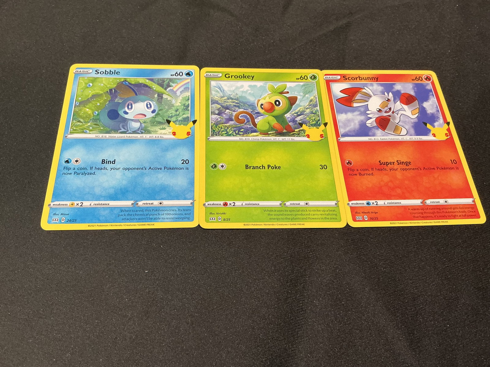 Pokemon 25th Anniversary Galar Starter Card Trio: Offered again, this Pokemon 25th Anniversary card trio features the Galar starter Pokemon Sobble #24/25, Grookey #8/25, and Scorbunny #16/25. Each card carries the Pikachu 25th Anniversary stamp,