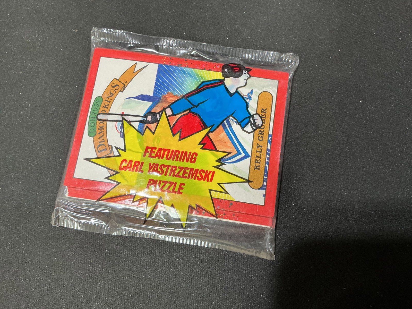 Donruss Diamond Kings Carl Yastrzemski Puzzle Pack: Sealed vintage Donruss Diamond Kings baseball collectible pack featuring a Carl Yastrzemski puzzle and Kelly Gruber artwork visible on the front. A colorful unopened baseball collectible with appeal