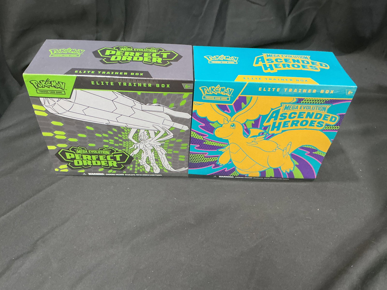 Perfect Order & Ascended Heroes ETB Pair: Two factory sealed Pokemon Mega Evolution Elite Trainer Boxes paired together in one lot: Perfect Order featuring Mega Zygarde artwork and Ascended Heroes featuring Dragonite artwork. This