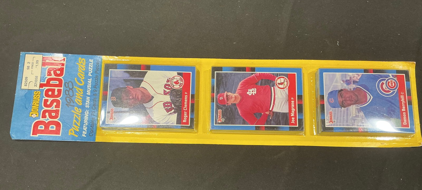 1988 Donruss Baseball Puzzle & Cards Rack Pack: Unopened 1988 Donruss Baseball Puzzle and Cards rack pack containing 76 cards plus Stan Musial puzzle pieces. Visible cards include Roger Clemens, Joe Magrane, and Damon Berryhill, giving this vintage