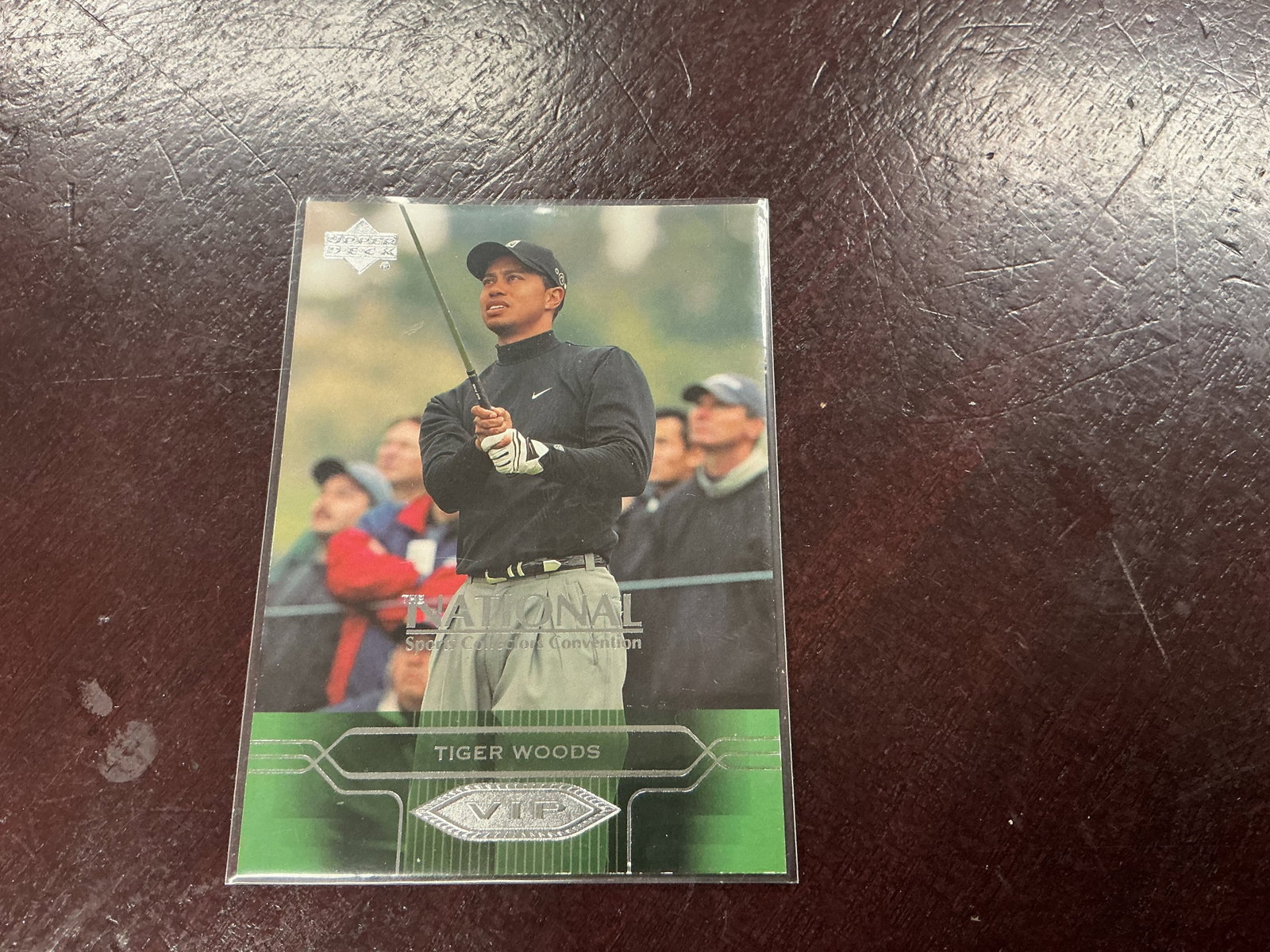 2004 Upper Deck VIP Tiger Woods National Card: 2004 Upper Deck VIP Tiger Woods golf card produced for The National Sports Collectors Convention. Features Woods following a shot with a large VIP emblem and The National convention branding across