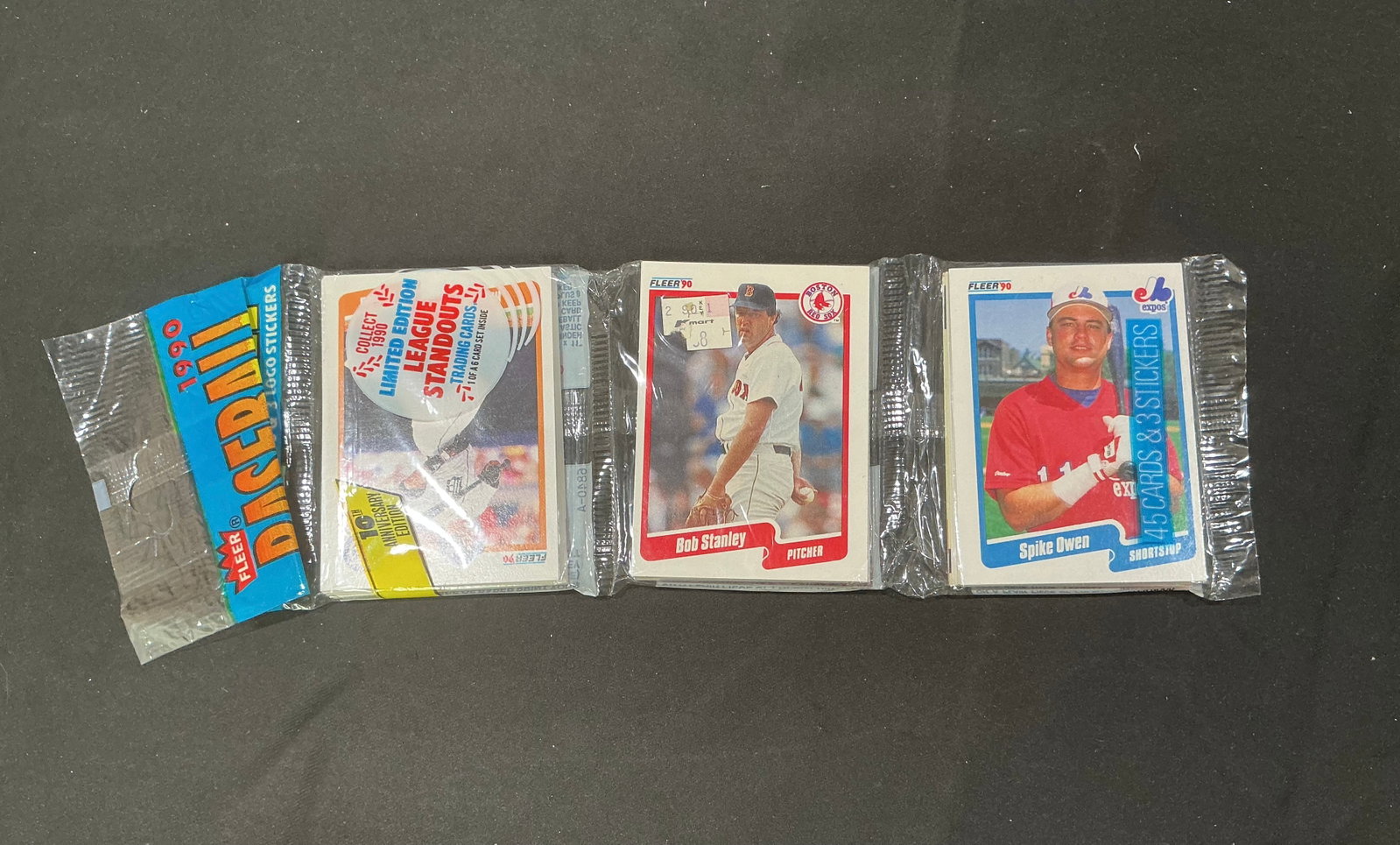 1990 Fleer Baseball Limited Edition Standouts: Vintage 1990 Fleer baseball limited-edition packaged card assortment featuring League Standouts and stickers. Visible cards include Boston Red Sox pitcher Bob Stanley and Montreal Expos shortstop