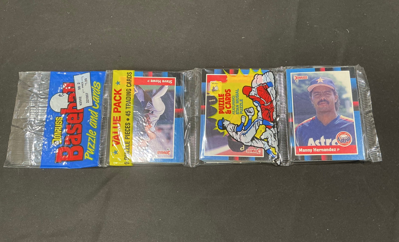 1988 Donruss Baseball Value Pack Sealed: Sealed 1988 Donruss Baseball value pack containing 45 trading cards plus puzzle pieces. Visible cards include Houston Astros pitcher Manny Hernandez, while the reverse side shows Steve Howe. Original 
