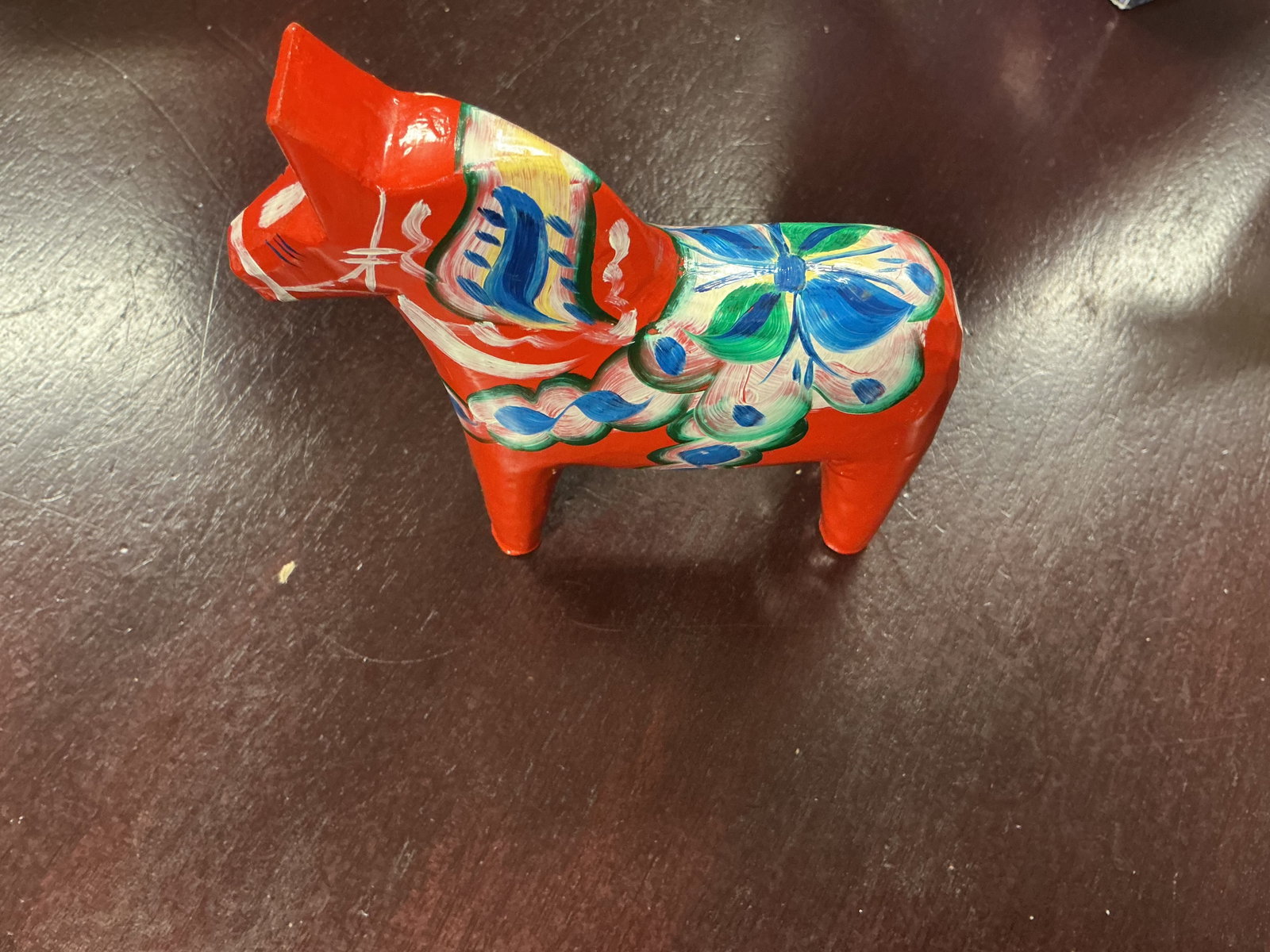 Swedish Dala Horse Red Hand Painted Folk Art: Traditional Swedish Dala horse, or Dalahast, carved in wood and hand painted in bright red with colorful blue, green, white, and yellow floral kurbits-style decoration. Marked "Mora" on the rear and