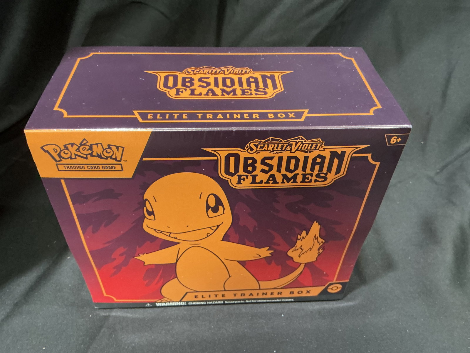 Pokemon Obsidian Flames Charmander Elite Trainer Box: Making its first auction appearance, this factory sealed Pokemon Scarlet & Violet Obsidian Flames Elite Trainer Box features Charmander artwork and includes nine Obsidian Flames booster packs, a