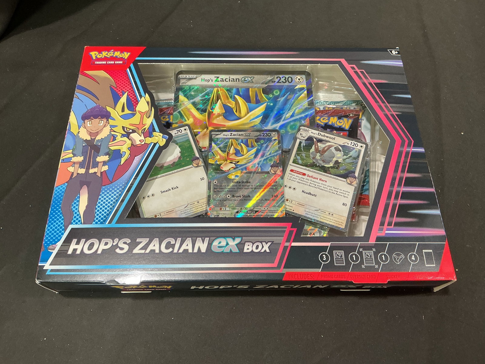 Pokemon Hop's Zacian ex Box Sealed: Making its first auction appearance, this factory sealed Pokemon TCG Hop's Zacian ex Box features a foil promo card of Hop's Zacian ex, foil cards featuring Hop's Wooloo and Hop's Dubwool, and an over
