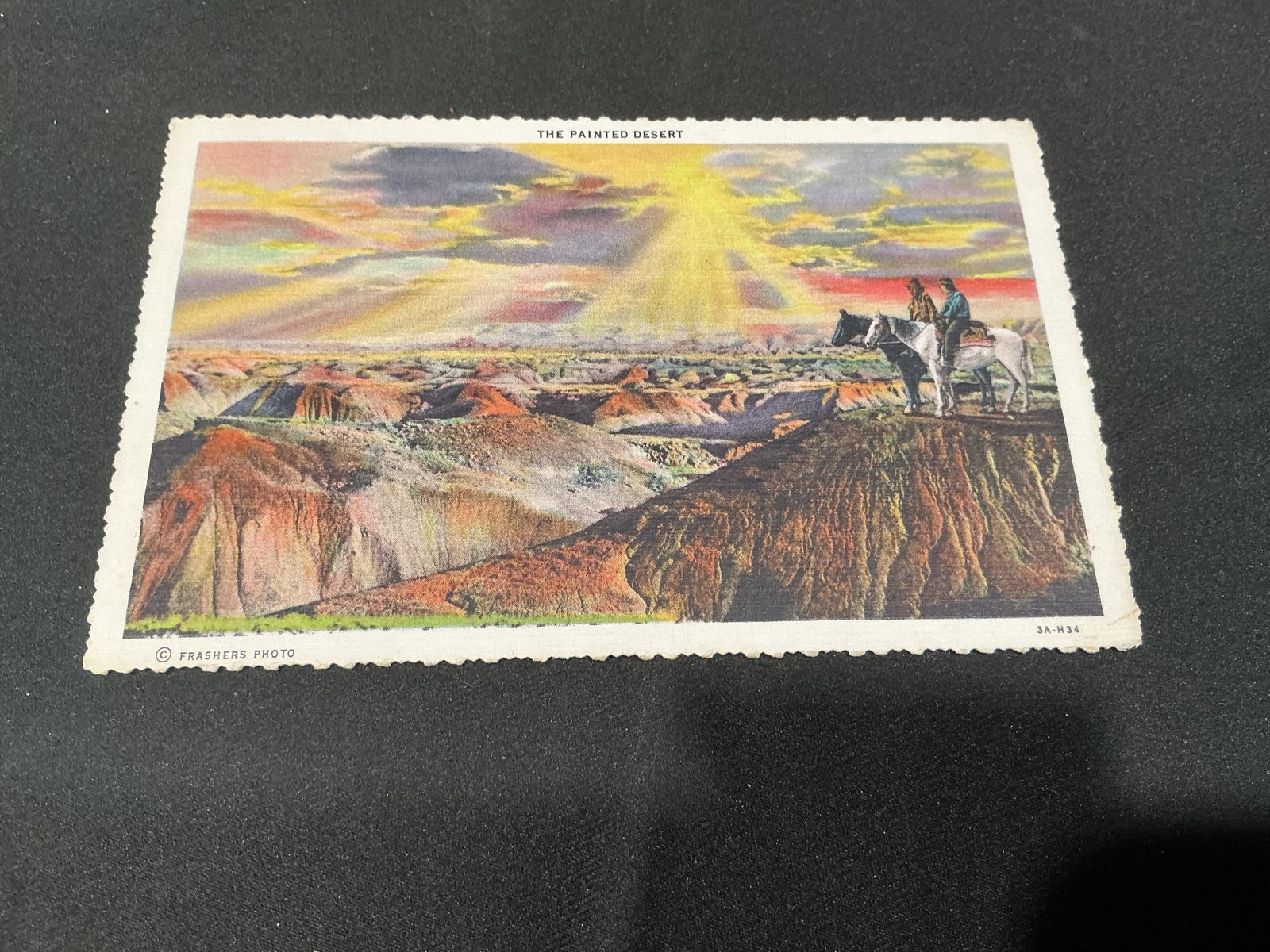 Vintage Painted Desert Arizona Frashers Photo Postcard: Showing the colorful Painted Desert beneath a dramatic sunset, this vintage Frashers Photo postcard depicts two horseback riders overlooking the expansive Arizona landscape. The reverse describes the