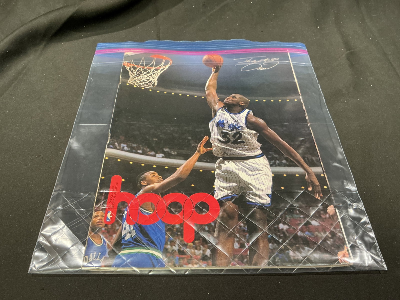 Shaquille O'Neal Orlando Magic NBA Hoops Magazine: Featured as a standout piece of 1990s basketball memorabilia, this vintage NBA Hoops official program magazine features Orlando Magic superstar Shaquille O'Neal soaring toward the basket in his #32 pi