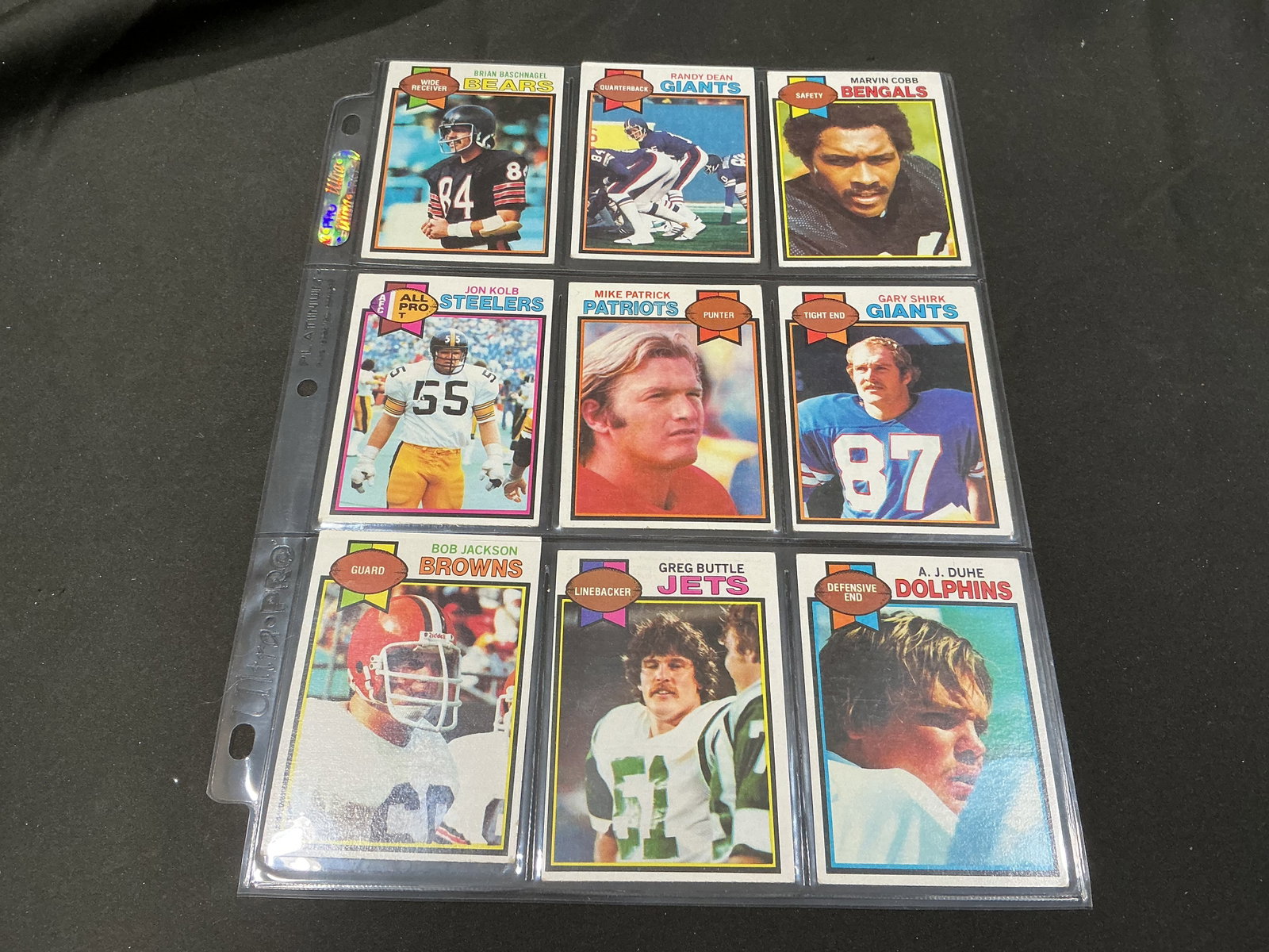 1979 Topps Football Jon Kolb A.J. Duhe 9-Card Group: A nine-card 1979 Topps football grouping highlighted by Pittsburgh Steelers All-Pro tackle Jon Kolb #234 and Miami Dolphins defensive end A.J. Duhe #162. Also included are Brian Baschnagel #154, Randy