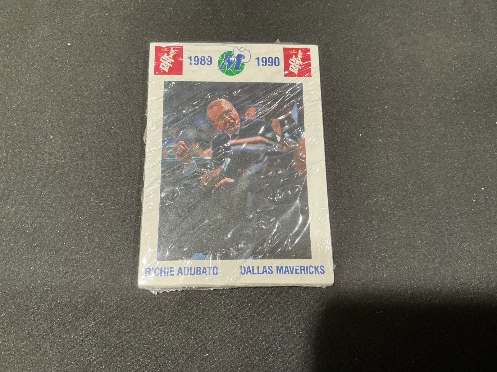 1989-90 Dallas Mavericks Dr Pepper Team Card Set Sealed: New to the auction, this sealed 1989-90 Dallas Mavericks promotional team card set features Dr Pepper branding and period Mavericks photography. Assistant coach Richie Adubato is visible on the front 