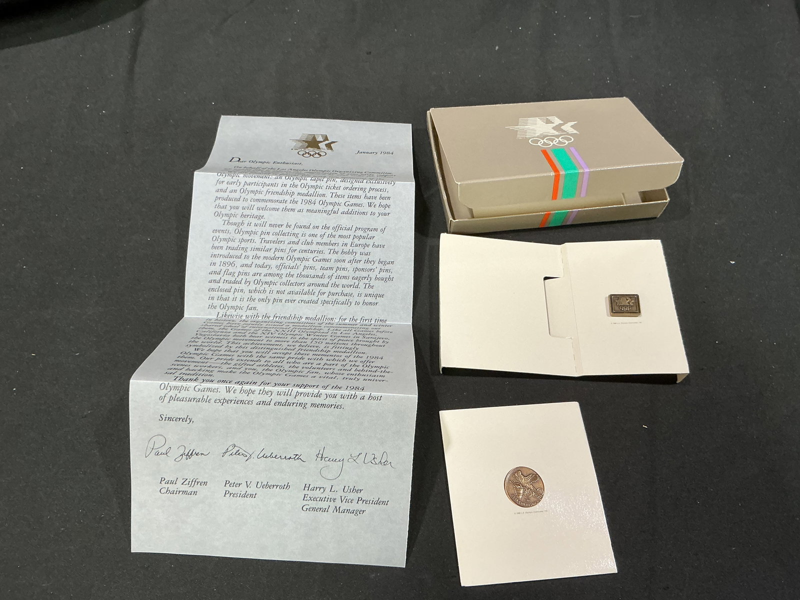 1984 Los Angeles Olympics Early Supporter Pin Medallion Set: A distinctive 1984 Los Angeles Olympic Games early-supporter presentation set retaining its original striped Olympic box, January 1984 Los Angeles Olympic Organizing Committee letter, collector pin, a