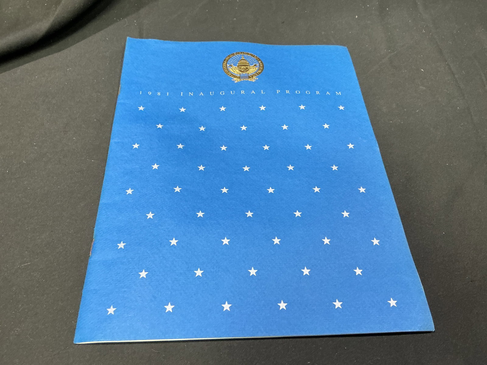 1981 Ronald Reagan George Bush Official Inaugural Program: An original official program from the January 20, 1981 inauguration of President Ronald Reagan and Vice President George H. W. Bush. The distinctive blue cover carries a field of silver stars beneath 