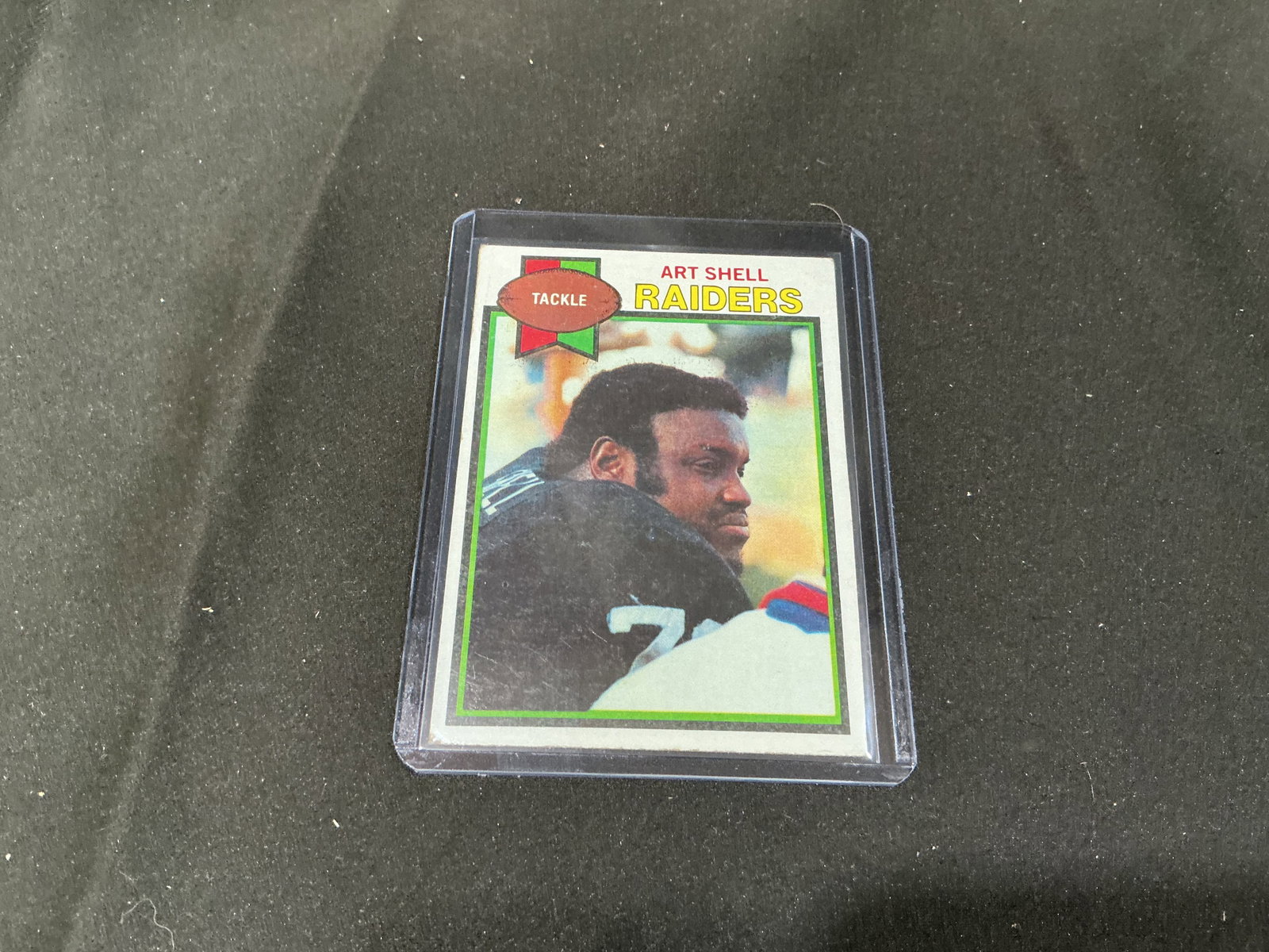 1979 Topps Art Shell Raiders #210 Pro Bowl Tackle: Highlighting one of the Oakland Raiders' standout offensive linemen, this 1979 Topps football card #210 features tackle Art Shell. The reverse notes his seven consecutive AFC Pro Bowl selections, 156 