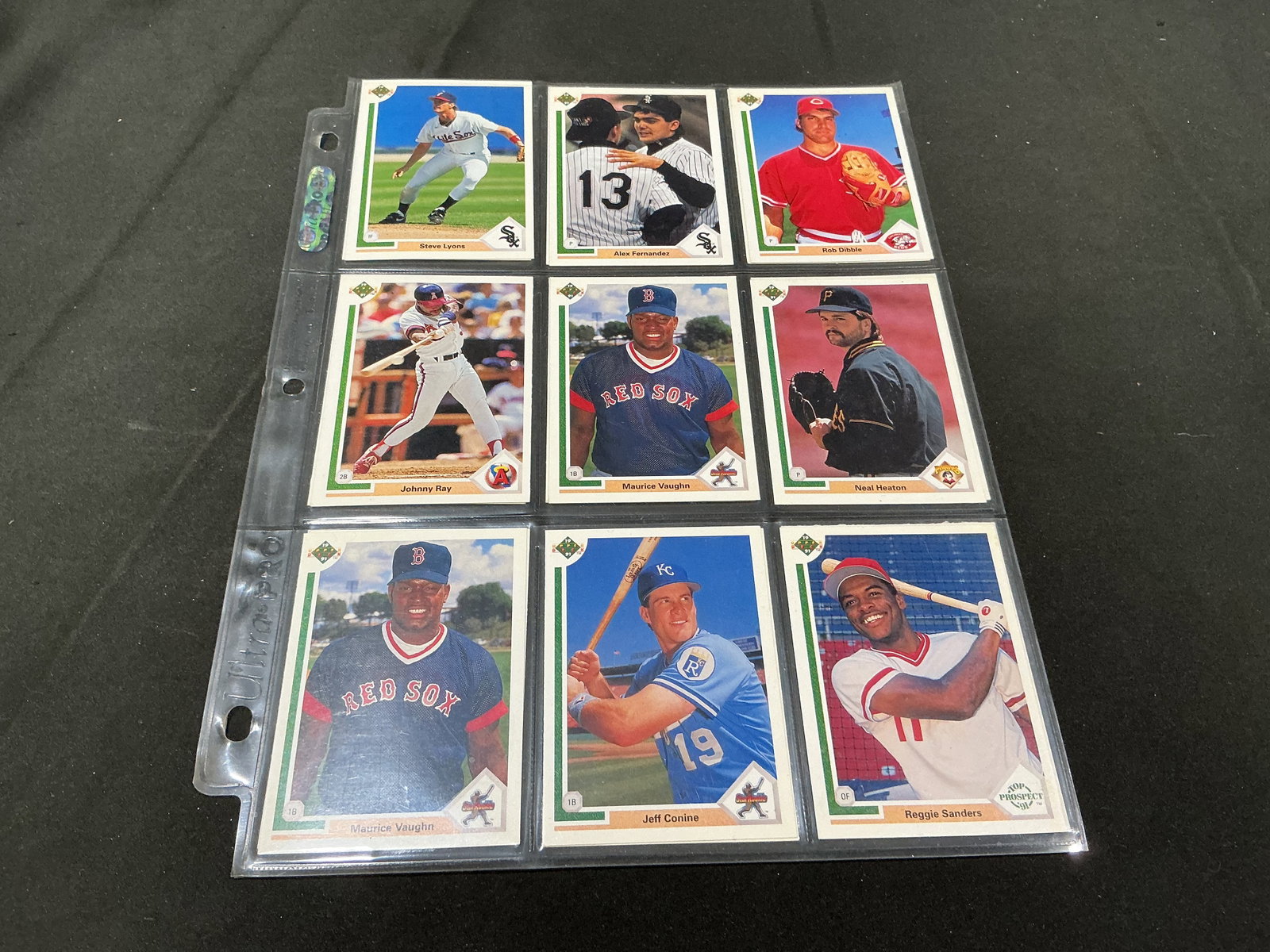 1990 Upper Deck Baseball Card Binder Lot: New to the auction, this binder-page collection features 1990 Upper Deck baseball cards with an assortment of Major League players and teams. Visible cards include Maurice Vaughn, Reggie Sanders, Dave