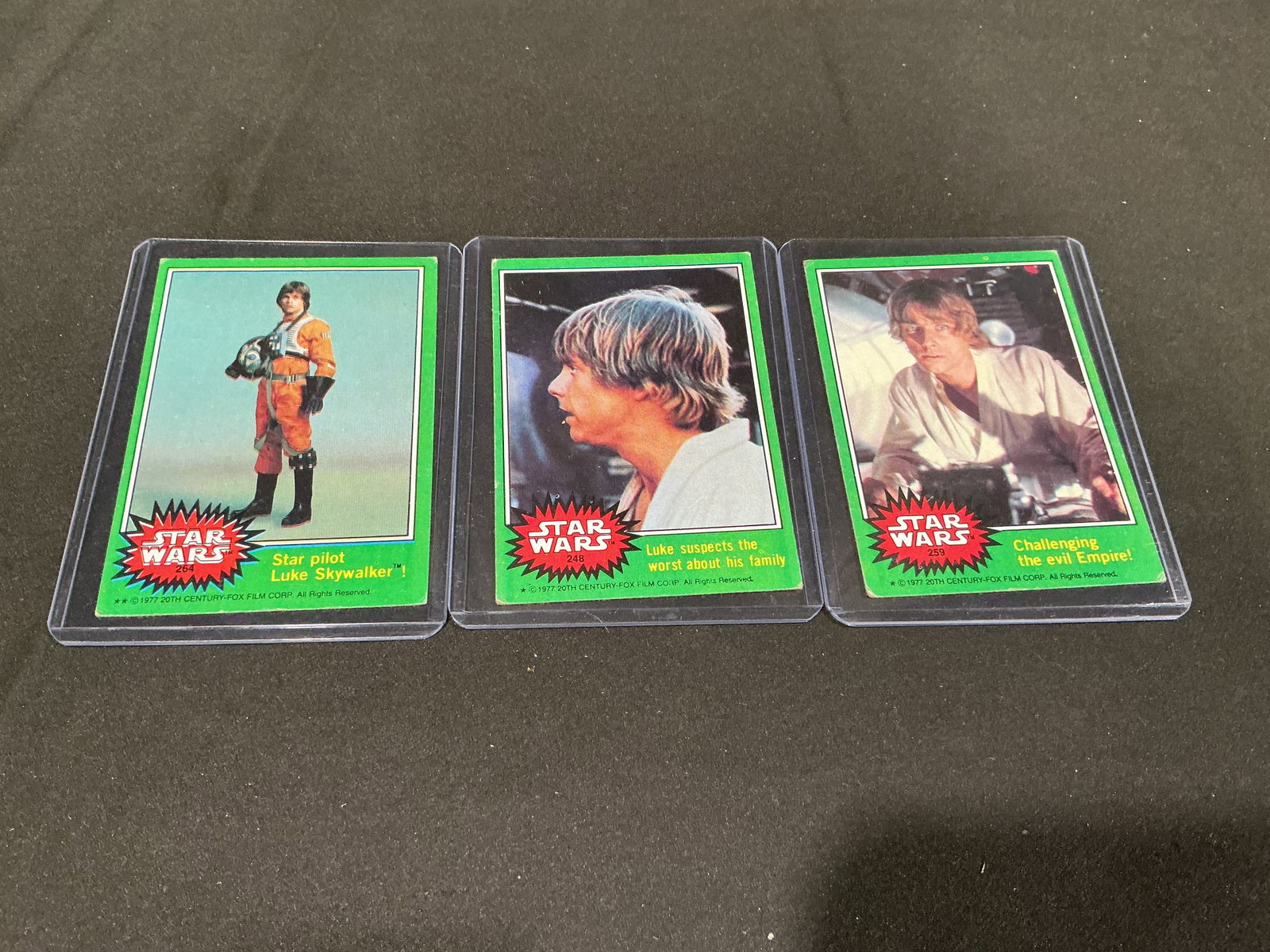 1977 Topps Star Wars Luke Skywalker Green Border Trio: Arriving in our auction for the first time is this trio of original 1977 Topps Star Wars green-border trading cards featuring Luke Skywalker. The group includes card #264 "Star pilot Luke Skywalker," 