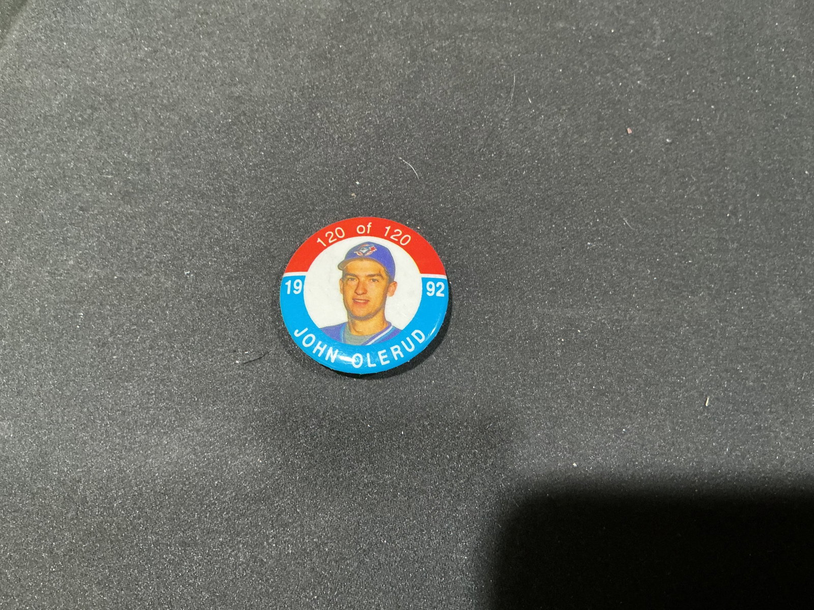 1992 John Olerud Toronto Blue Jays Limited Edition Pin: Featuring Toronto Blue Jays first baseman John Olerud, this 1992 photo pinback is individually numbered 120 of 120. The red, white and blue design presents Olerud in his Blue Jays cap with his name