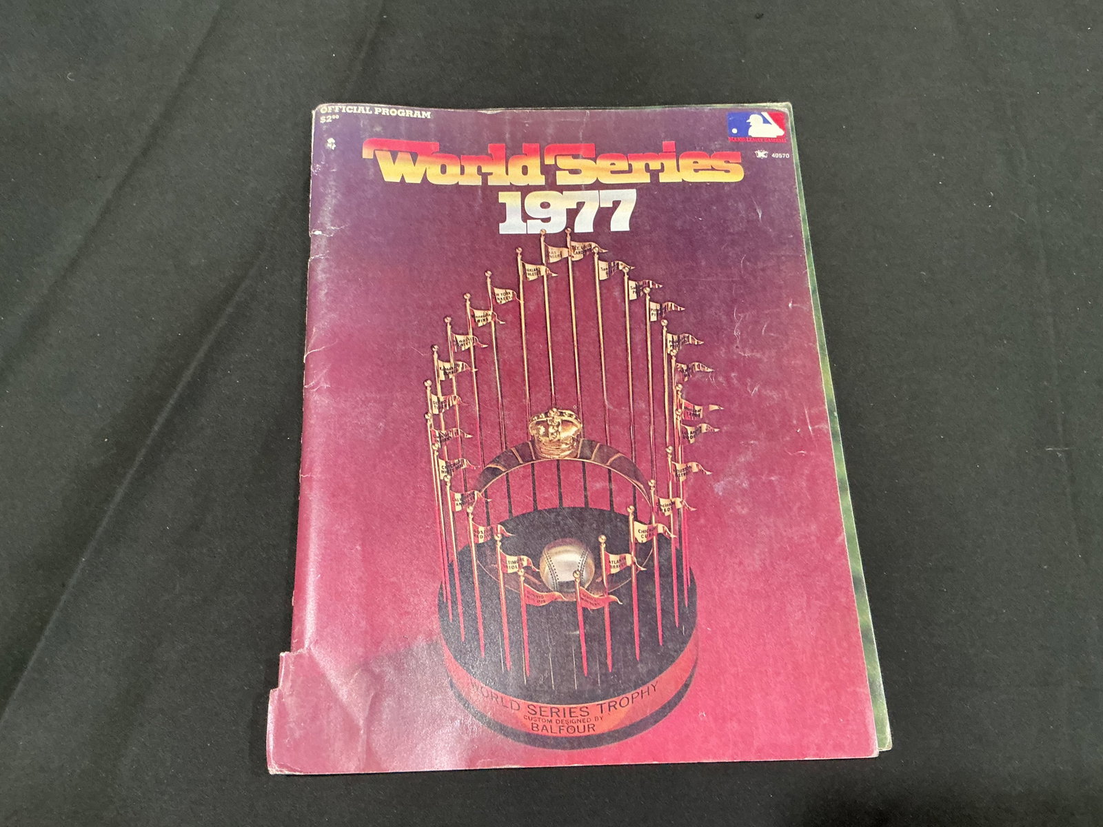 1977 World Series Official Program Yankees vs Dodgers: Opening the new section is an original 1977 World Series official program from the classic matchup between the New York Yankees and Los Angeles Dodgers. The cover features the World Series Trophy,