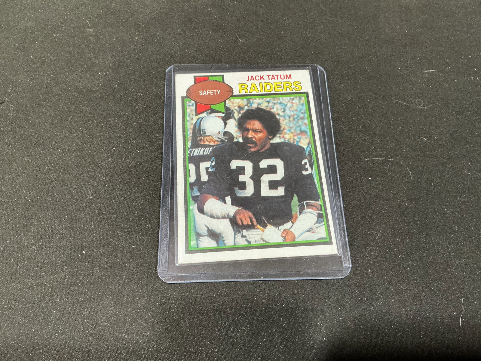 1979 Topps Jack Tatum Oakland Raiders #326: Oakland Raiders safety Jack Tatum is pictured in his black #32 uniform on this 1979 Topps football card #326. The card comes from the later years of Tatum's Raiders career and highlights the three-tim