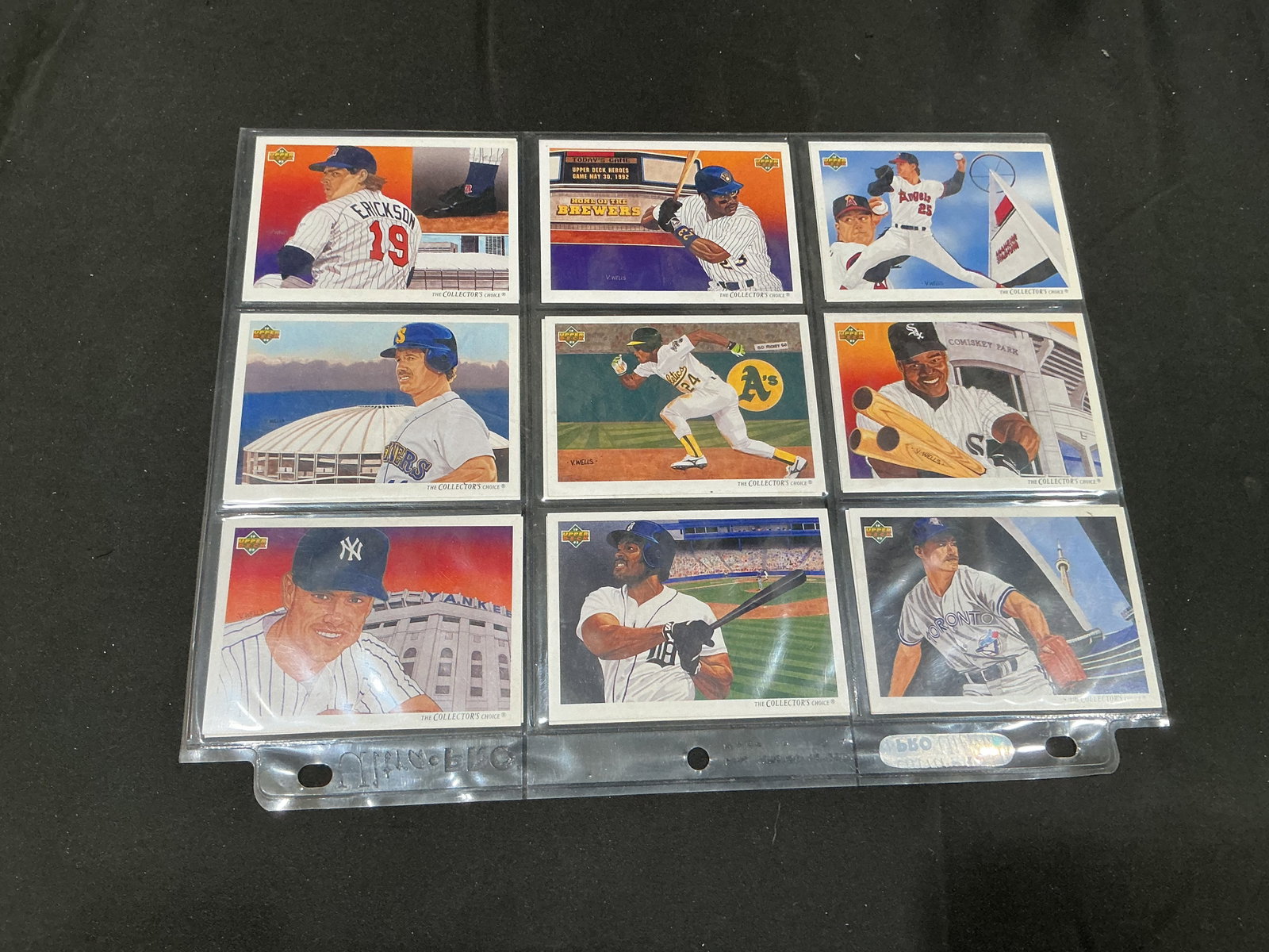 1992 Upper Deck Baseball Vernon Wells Art Card Lot: Two nine-pocket pages present a colorful assortment of 1992 Upper Deck baseball cards featuring Vernon Wells' distinctive painted artwork. The group includes subjects from the Twins, Brewers, Angels, 