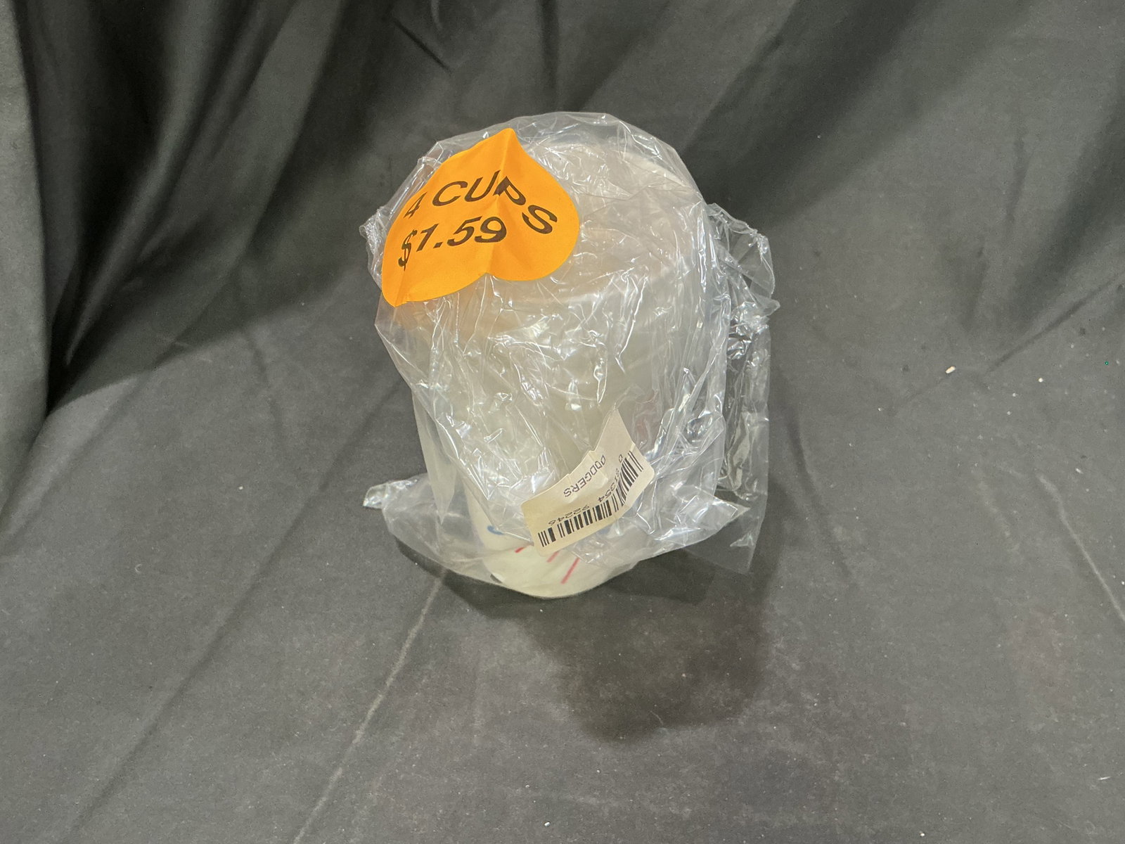 Vintage Los Angeles Dodgers Plastic Stadium Cups Sealed: A vintage stack of four Los Angeles Dodgers plastic beverage cups remains together in its original clear retail-style bag, still bearing an orange period price sticker marked "4 CUPS $1.59." Each