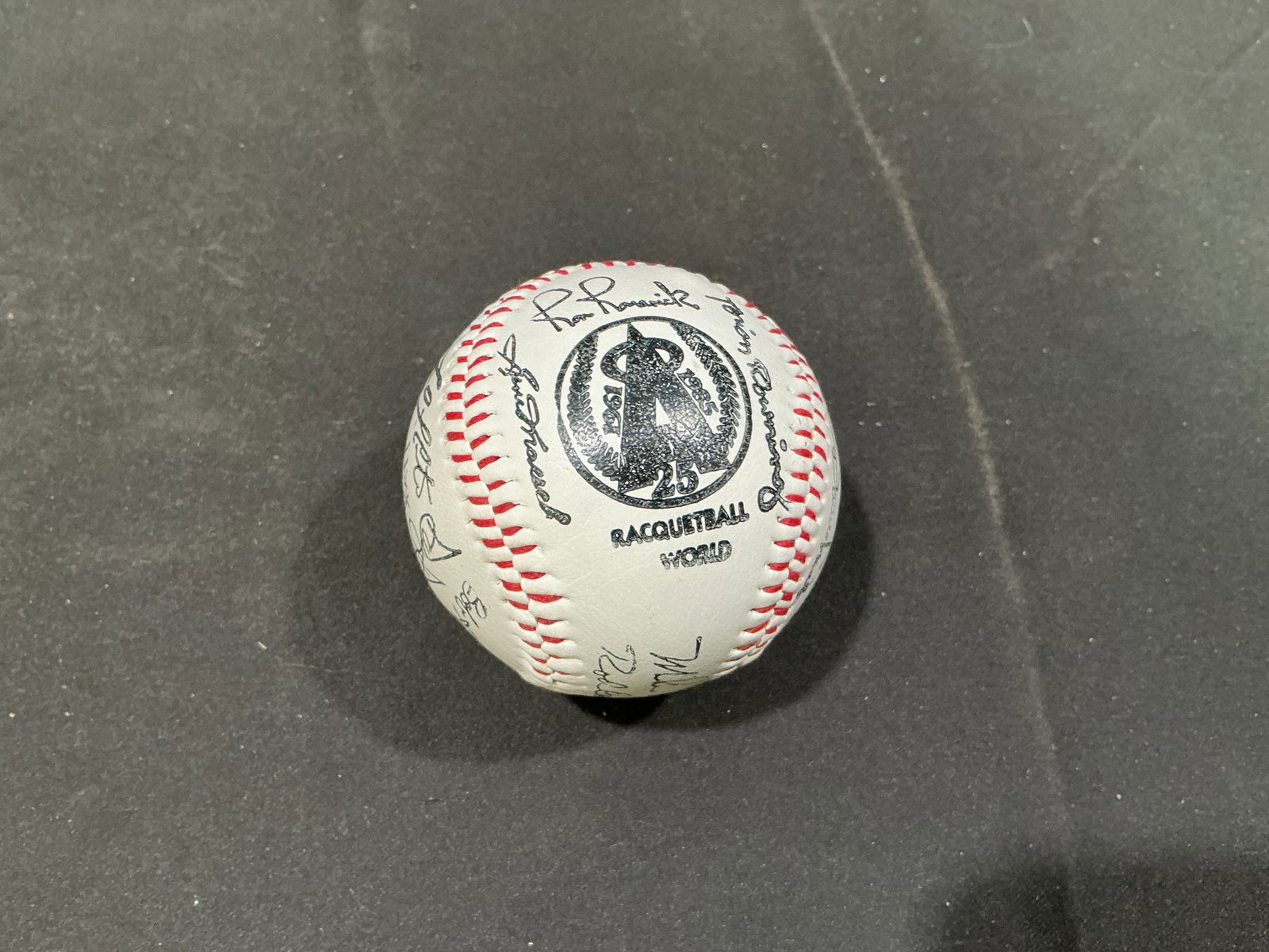 California Angels 25th Anniversary Multi-Signed Baseball: Commemorating the California Angels' 25th anniversary, this baseball is covered with numerous signatures across its panels and presents as a team-style autograph piece tied to the club's Silver