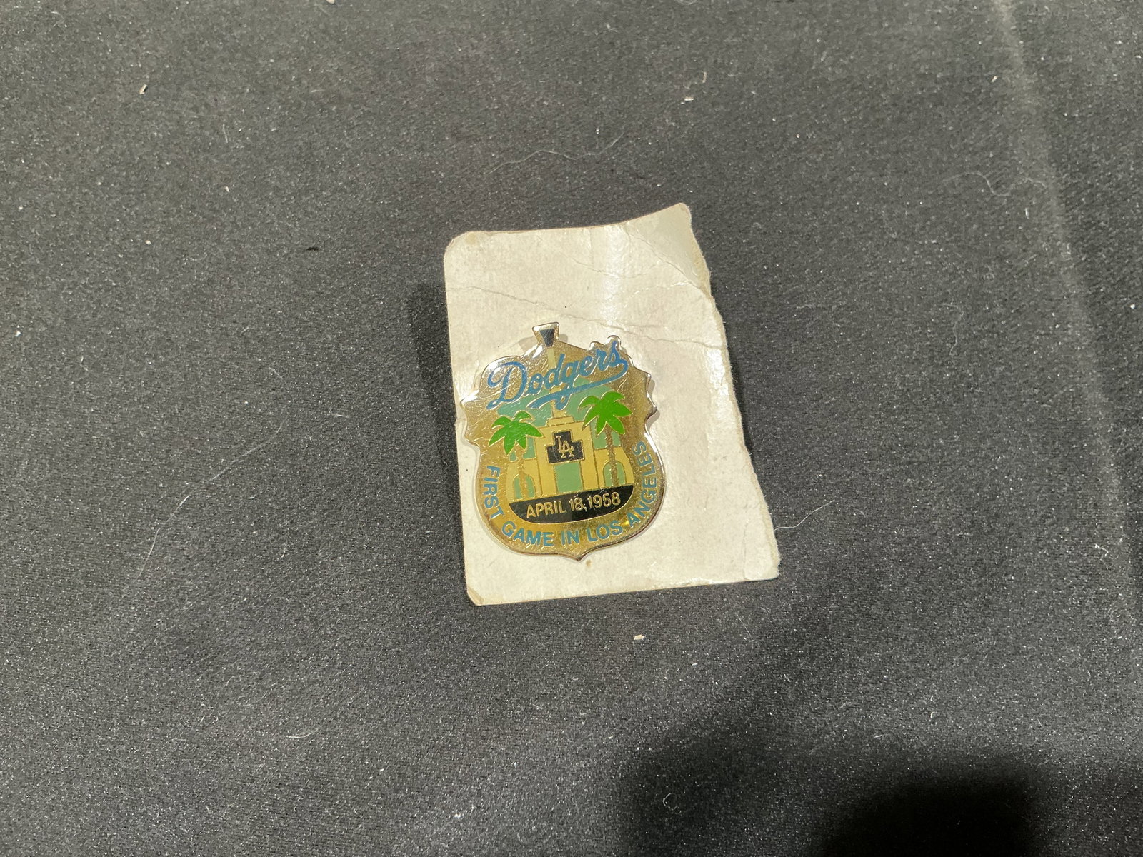 LA Dodgers First Game April 18 1958 Unocal Pin: Commemorating a landmark moment in Los Angeles baseball history, this Unocal 76 Dodgers pin marks April 18, 1958, the club's first game in Los Angeles. The gold-tone and enamel design depicts the Los