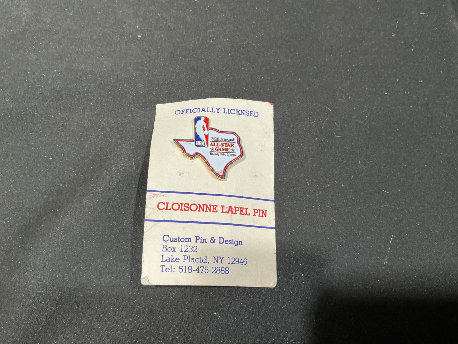 1986 NBA All-Star Game Dallas Cloisonne Lapel Pin: Commemorating the 36th Annual NBA All-Star Game held in Dallas on February 9, 1986, this officially licensed cloisonne lapel pin features the NBA logo incorporated into a Texas-shaped event emblem.