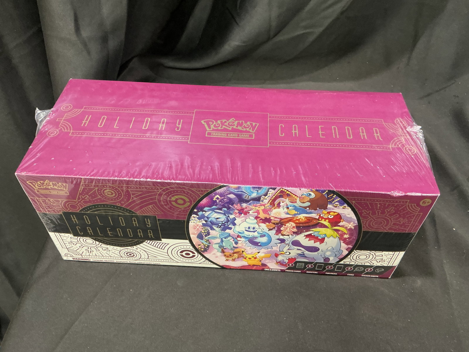 Pokemon TCG Holiday Calendar Factory Sealed: New to this auction, this factory sealed Pokemon Trading Card Game Holiday Calendar contains 25 daily surprises, including eight foil Pokemon TCG cards with festive stamps, six booster packs, seven