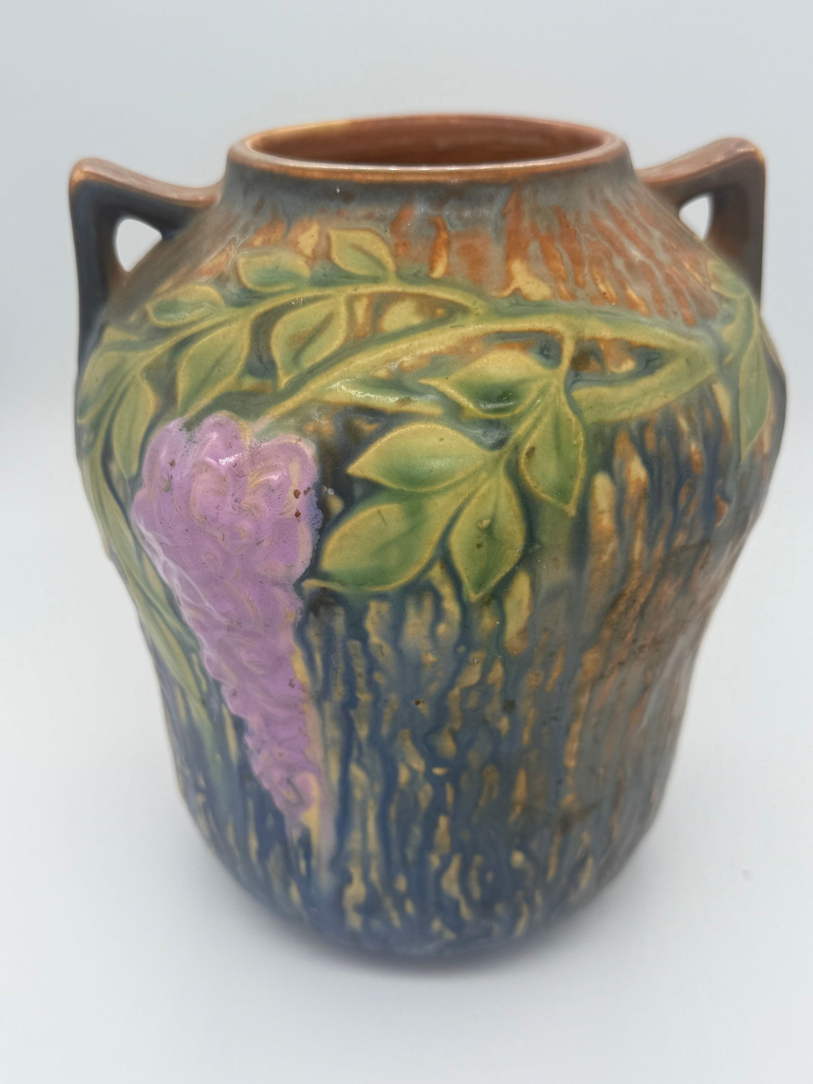 Antique Roseville Pottery Wisteria Vase: Stamped 9R. Measures 7.25 inches tall and 6.5 inches wide. Opening is 3 inches in diameter. Amphora style and introduced in 1933.