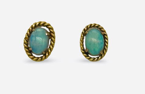14k Gold Opal Earrings: Gorgeous Oval Opal Stud Earrings surrounded by twisted gold frame. Each stud face measures .25 inch from top of oval to bottom. Weighing 1.8g. Earring Backs stamped 14K.