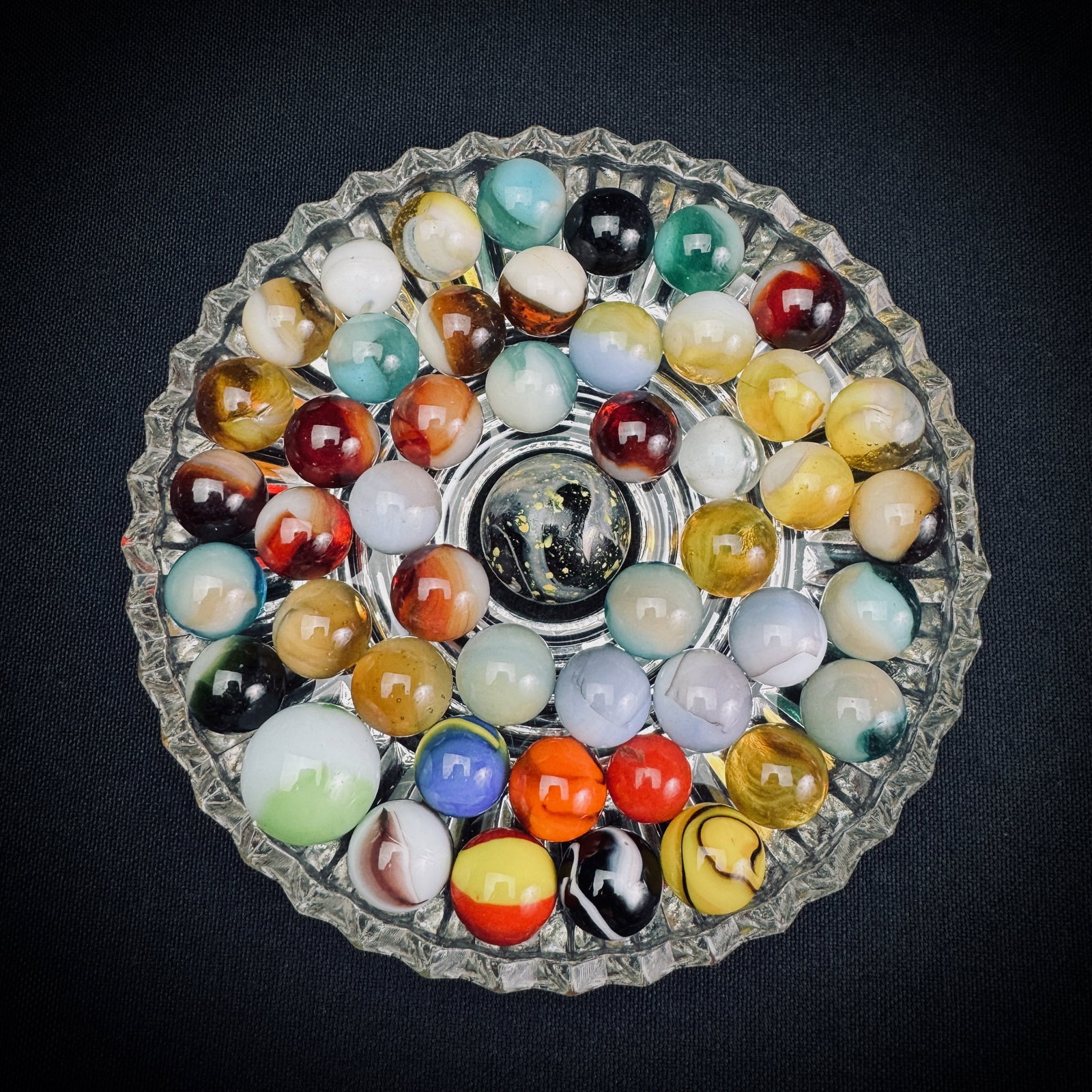 Lot of Vintage Glass Marbles w/ Shooter: A collection of glass marbles in various styles and colors. This lot includes numerous player-sized marbles and one larger shooter. Types represented appear to include slags, swirls, and solids. Glass