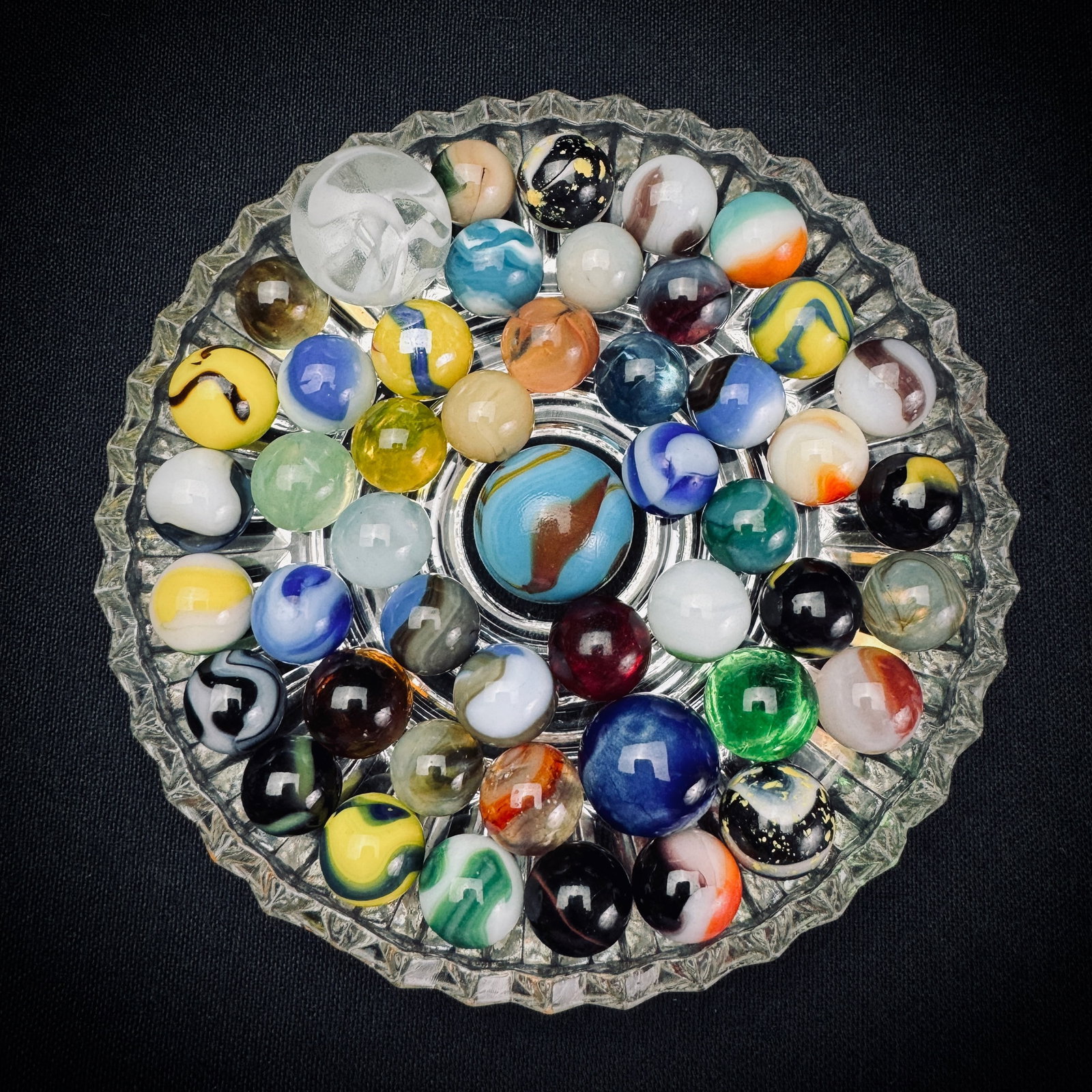 Lot of Assorted Vintage Glass Marbles: This is a collection of assorted vintage glass marbles. The lot includes numerous colors and patterns, such as swirls, patches, and slags. The group features several larger shooter or boulder-sized ma
