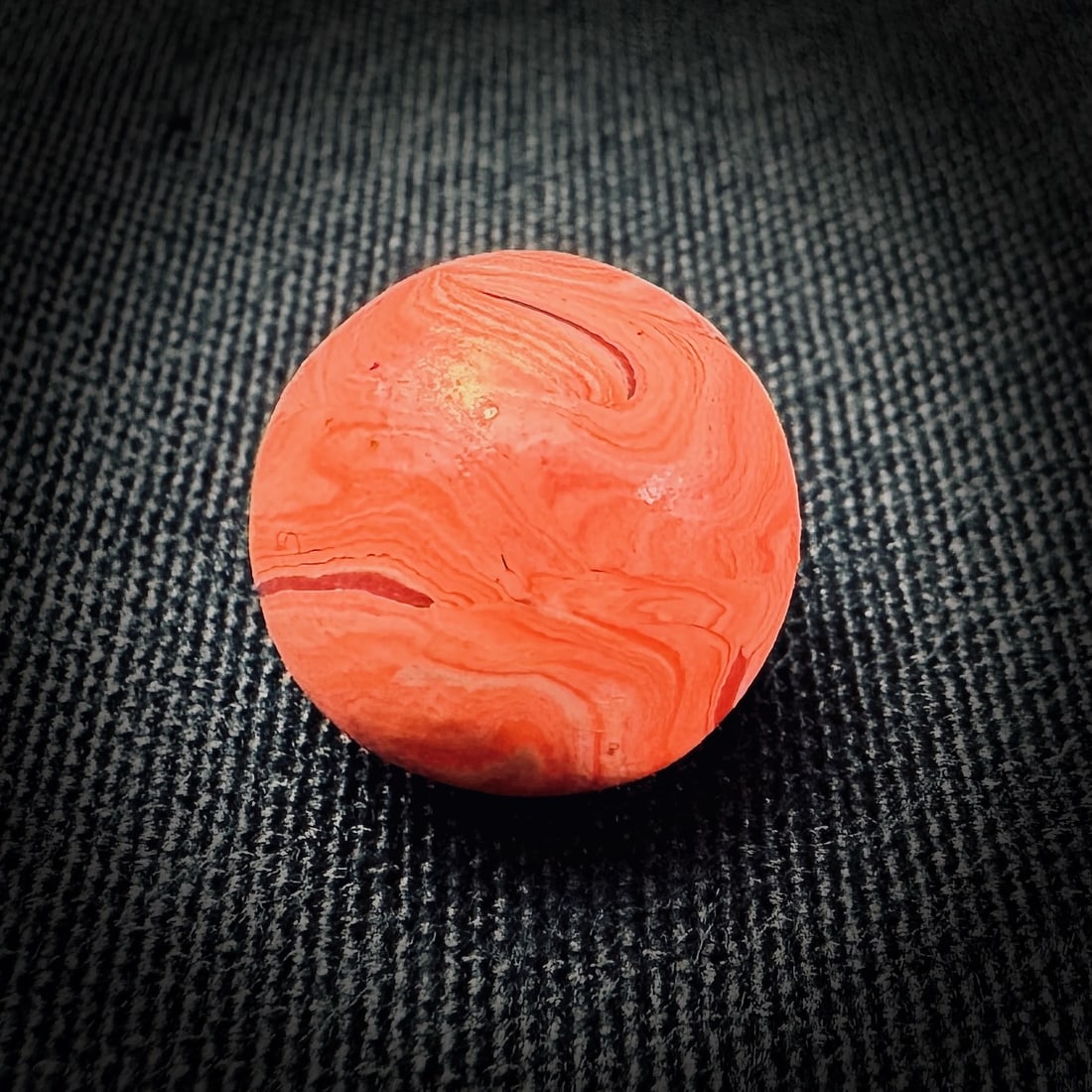 Orange Swirl Un-glazed Clay Marble: This lot contains a single un-glazed clay marble. It features an orange and white swirl pattern. The marble measures approximately 0.64 inches in diameter. Clay Marble Unglazed Ceramic Swirl Orange Be