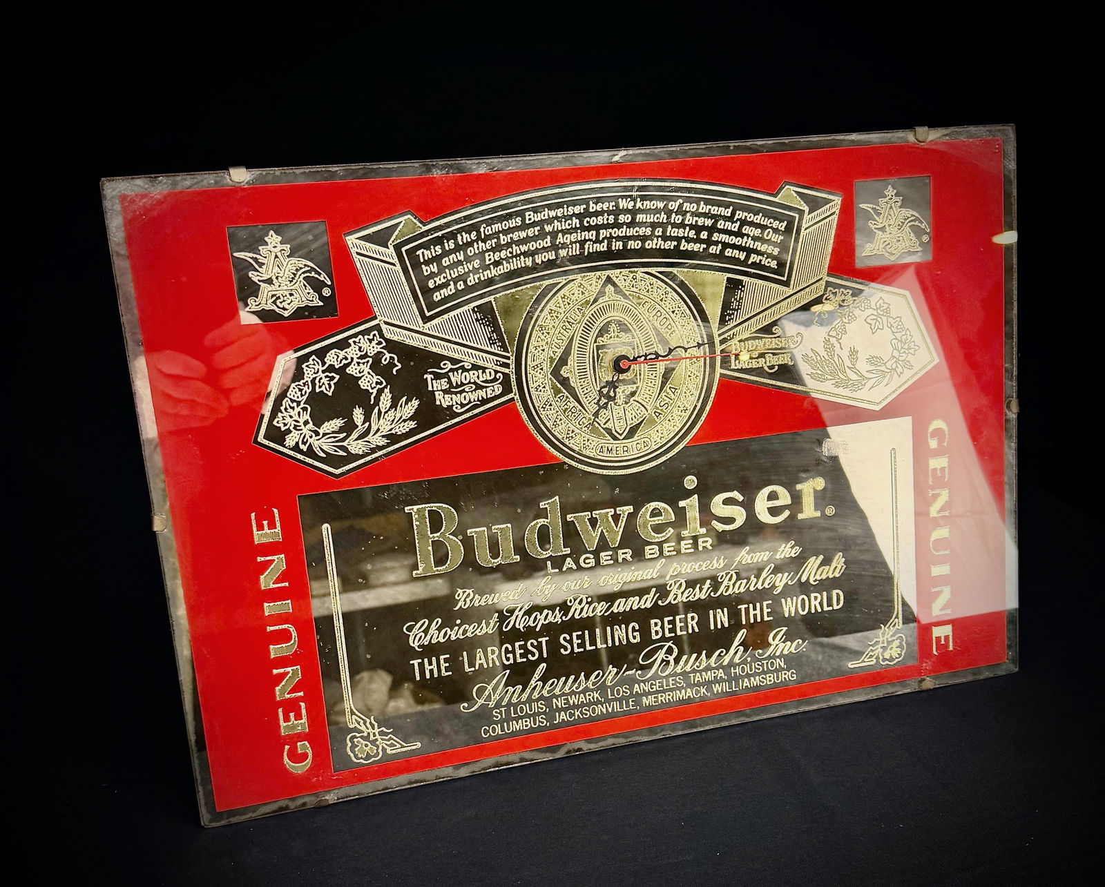Budweiser Beer Label Advertising Wall Clock: This is a wall clock featuring the classic Budweiser beer label design. The sign displays graphics for Anheuser-Busch, Inc., brewed from the 'Choicest Hops, Rice and Best Barley Malt'. The design is r