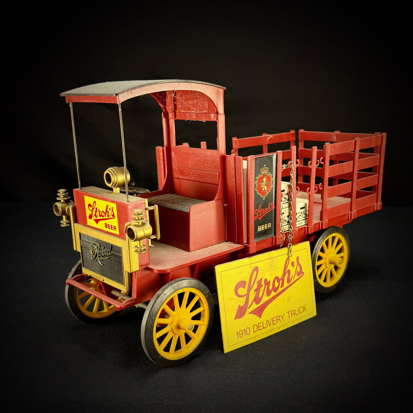Stroh's Beer 1910 Rapid Delivery Truck Model: This is a model of a 1910 Rapid Motor Vehicle Company delivery truck. The truck features advertising for Stroh's Beer, with logos on the cab and a decal on the front. It includes several replica beer 