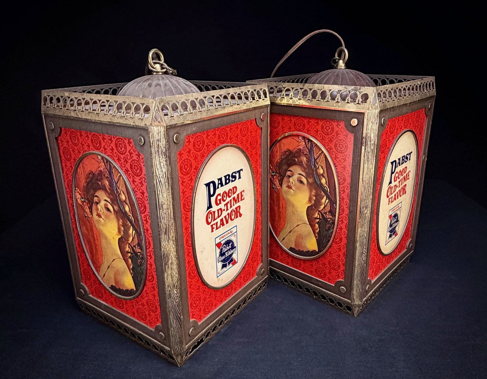 Pair of Pabst Blue Ribbon Hanging Lanterns: This lot consists of a pair of Pabst hanging beer lanterns. Each four-sided light features different advertising panels, including the Pabst Blue Ribbon logo, the 'Good Old-Time Flavor' slogan, and a