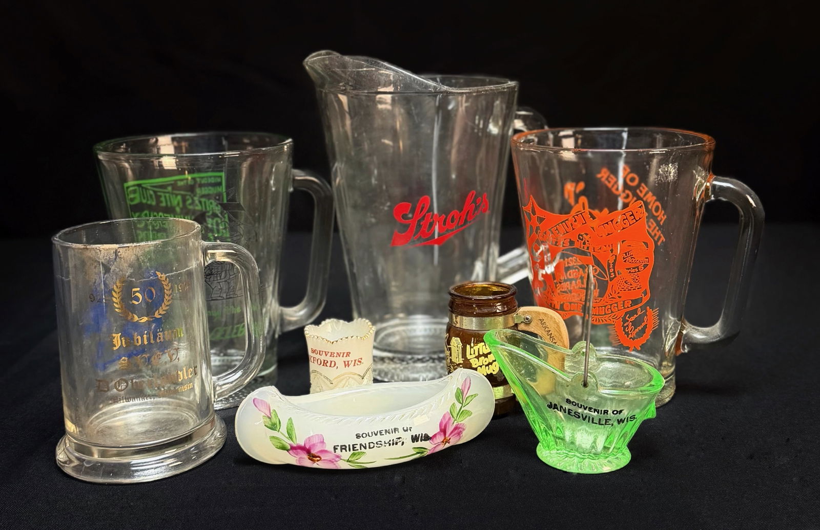Vintage Glassware Lot WI Souvenirs Barware: This is a lot of assorted vintage glassware and souvenir items. The collection includes a Stroh's beer pitcher, several mugs, and a variety of toothpick holders. Souvenir locations include Janesville,