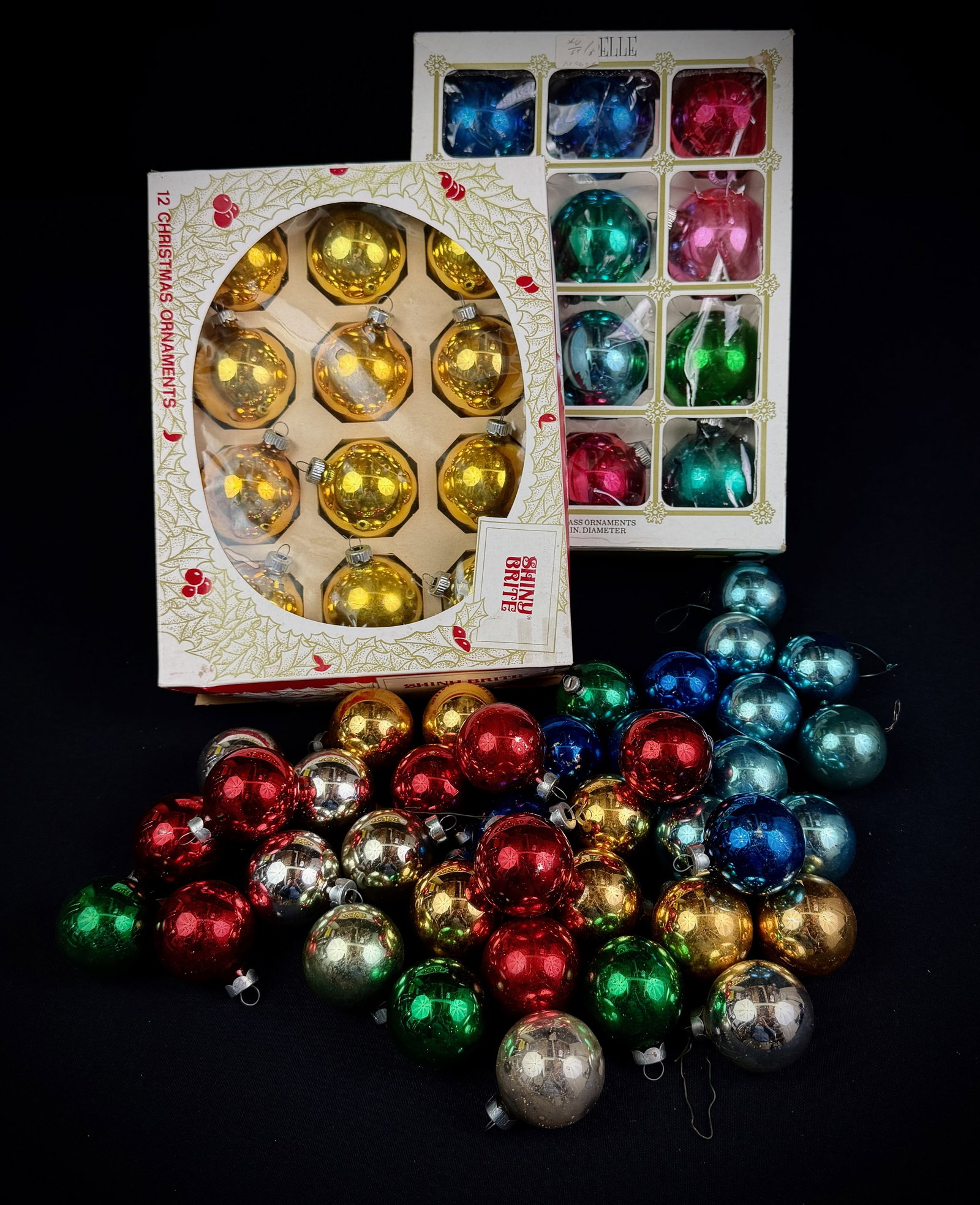 Vintage Shiny Brite & Elle Glass Ornaments: A large lot of vintage mid-century glass Christmas ornaments. This collection includes one box of twelve gold indented Shiny Brite ornaments and one box of twelve multi-colored Elle brand ornaments. A