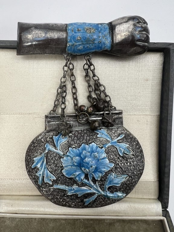 Antique Chinese Silver Enamel Floral Motif Brooch: Antique Chinese Silver Enamel Floral Motif Brooch. Antique enamel decorated and chase work engraved purse form figural brooch. Measures approximately 4 inches in length. This lot is apart of a lifetim