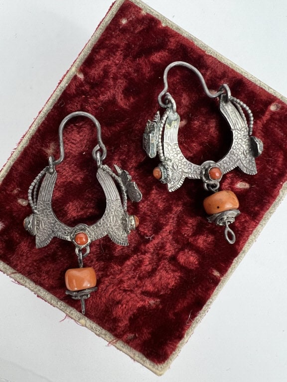 Pair of Antique Chinese Silver & Coral Earrings: Pair of Antique Chinese Silver & Coral Earrings. Each with coral cabochons and pendants drops. Butterfly design motif. Each approximately 1.75 inches in length. This lot is apart of a lifetime collect