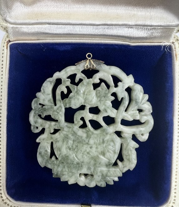 Estate Chinese Carved Jade Necklace Pendant: Estate Chinese Carved Jade Necklace Pendant. Carved jade necklace pendant with scene of flower plant and plant. Carved on both sides and set with bail. Measures just over 2.5 inches in length. This lo
