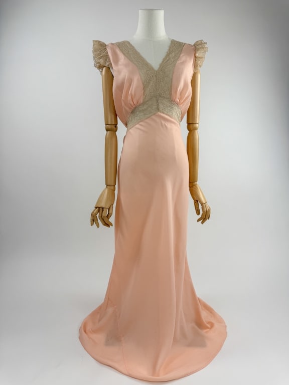 Vintage 1940s Pink Rayon Lace Bias Cut Slip Dress: Vintage 1940s Pink Rayon Lace Trim Bias Cut Slip Dress Night Gown. Lace insert at bust and ruffled lace at sleeves. Bias cut throughout with stretch. Attached tie at waist. Good vintage condition with