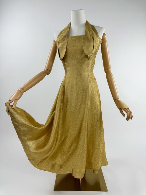 Vintage 1950s Pinup Gold Lamé Halter Dress: Vintage 1950s Pinup Gold Lamé Rockabilly Halter Cocktail Party Dress. Center back zip closure, snaps at back neck. Strapless dress with petal cupped halter. Slightly trained in rear skirt. Light 