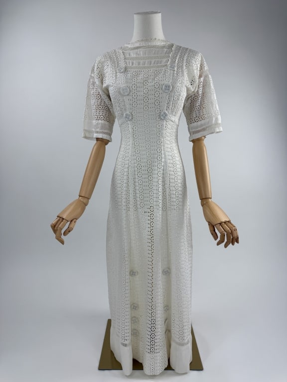 Antique 1900s White Eyelet Lace Lawn Tea Dress: Antique Edwardian 1900s White Cotton Eyelet Lace Lawn Tea Dress. Eyelet lace throughout with crochet details at neck and sleeves. Decorative buttons throughout. Closes at back with hooks. Boned throug