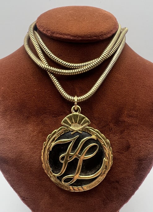 Vintage German Karl Lagerfeld Costume Necklace: Vintage German Karl Lagerfeld Costume Necklace. Vintage costume jewelry gilt metal Karl Lagerfeld necklace pendant on articulated gilt metal chain. Back of pendant is signed with logo. Chain measures 