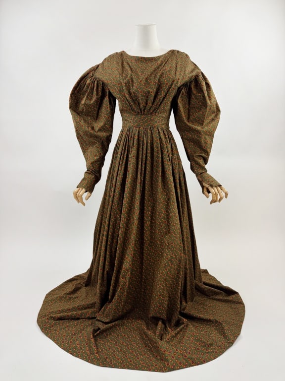Antique Reproduction 1830 Printed Cotton Day Dress: Antique Reproduction 1830s Printed Cotton Day Dress. Long balloon sleeves with ruching through waist and bust. Hooks and snaps up center back. Floral printed throughout. 36 inch bust, 26 inch waist 58