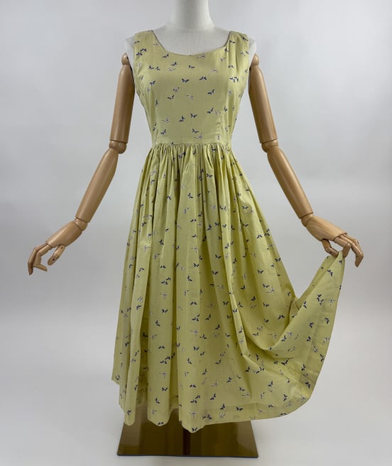 Vintage 1950s Cotton Butterfly Print Day Dress: Vintage 1950s Yellow Cotton Butterfly Print Sleeveless Day Dress. Round neckline. Zips at side to close. Ruched through waist. Measures 36 inch bust, 27 inch waist, 40 inches long.