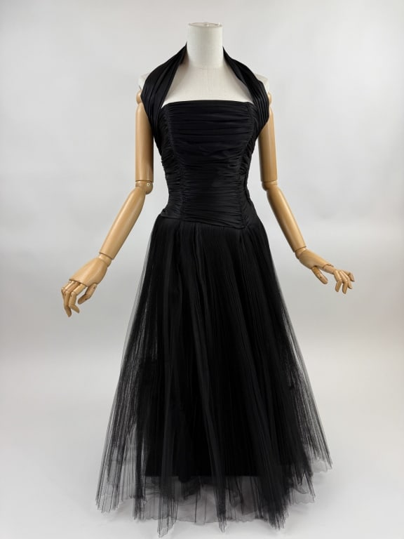 Vintage 1950s Black Pleated Cocktail Party Dress: Vintage 1950s Black Ruched Pleated Cocktail Party Rockabilly Pinup Halter Dress. Halter neckline with ruched knit boned bodice. Zips at side to close. Pleated through full skirt. Light wear throughout