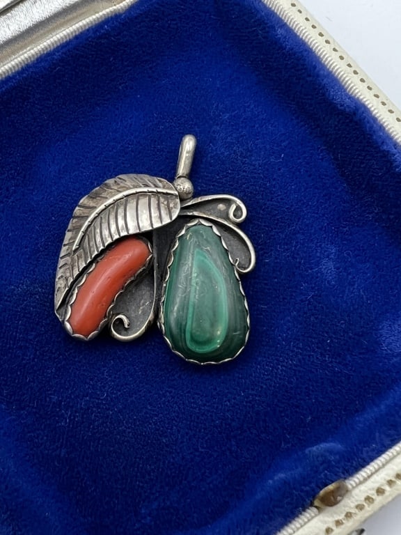 Vintage Native American Sterling & Coral Pendant: Vintage Native American Sterling & Coral Pendant. Necklace pendant in sterling silver and set with malachite and coral. Signed NU on the back. Measures just over 1.25 inches in length.